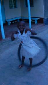 Joy with a bike tire "hulahoop". No...her name is Joy.