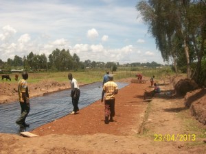 Moisture barrier.  Under that is a rock/gravel/sand base and rock/concrete footers.
