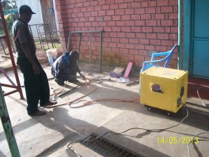 Welding the window and doors on-site for custom fit.