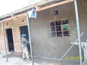 Throwing the plaster (cement) up on the wall.  I've tried it...much harder than it looks.