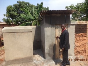 Pastor at the new boys latrine and bath house