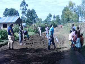 Greg leading a team to improve road drainage and eliminate mud near the orphanage.