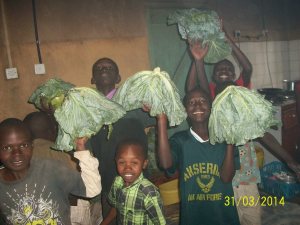 Boys with the fruits of their labors and their own garden plots.
