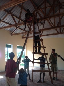 The boys "helping" John install the LED Strip lights in the Dining Hall. The lights are powered by solar charged batteries.
