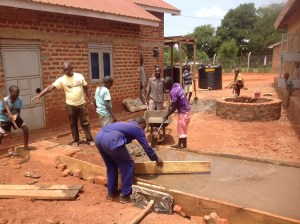 Here's Pastor Moses, who joined us from Kenya, teaching and directing the kids in the art of concrete work. We added walkways between the buildings.