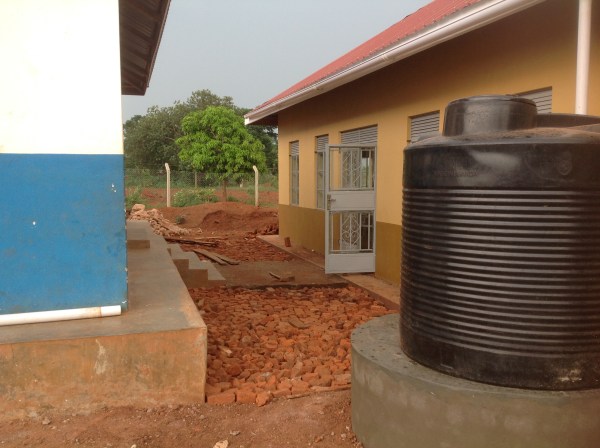 Installed gutters and rain collection tanks on both sides of the Dining Hall as well as the boys dorm. Collecting water reduces mud and is used for cleaning. We also added concrete walkways between the buildings.