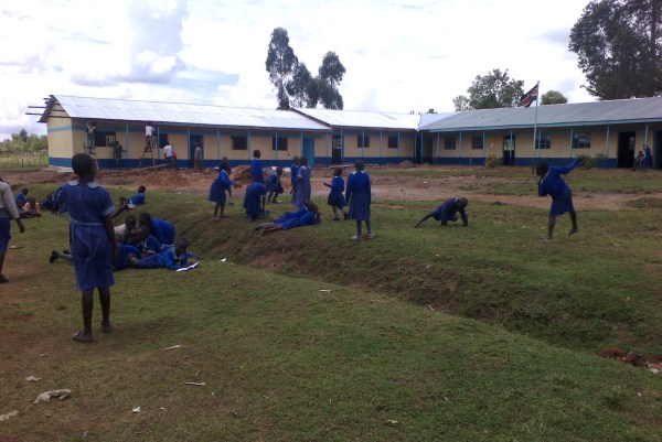 LSA kids playing in the foreground of the new building.